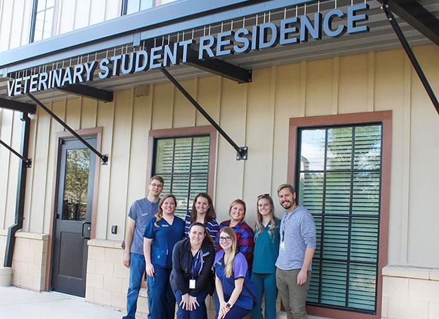 DVM students pose in front of the Houston SPCA Veterinary Student Residence